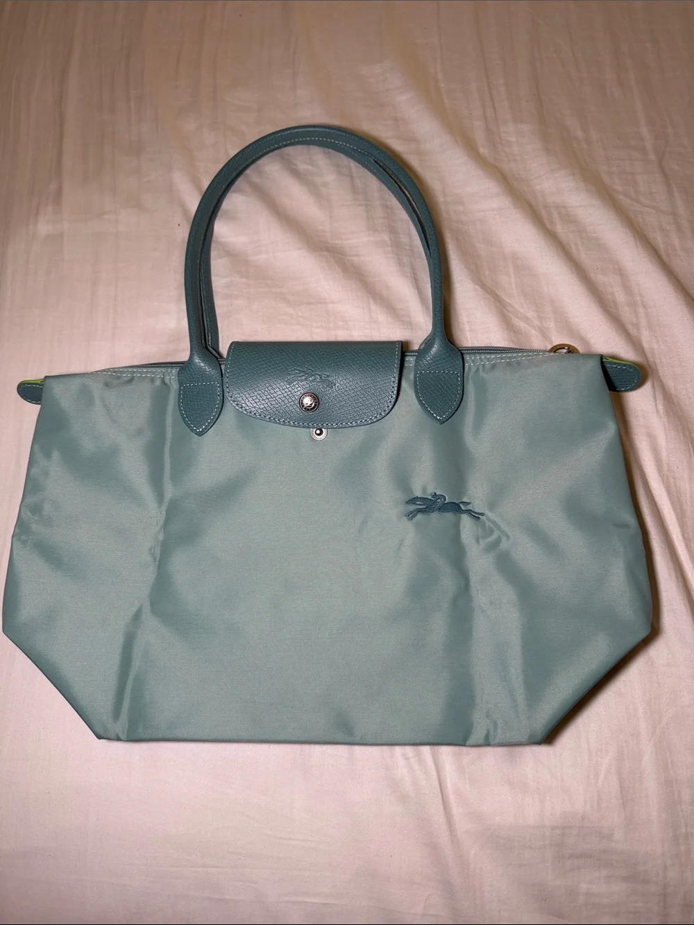 Longchamp le pliage is tote in light turquoise